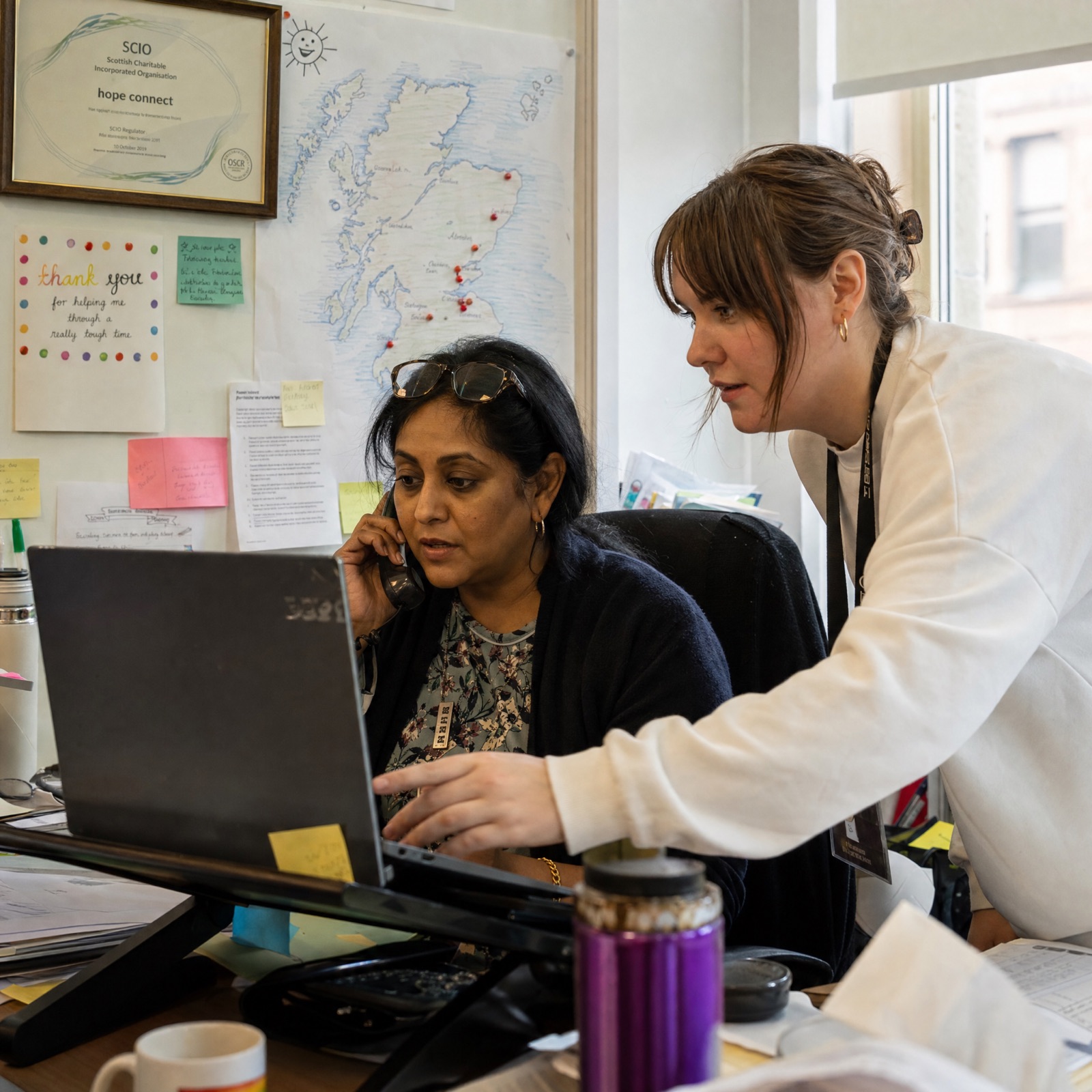 A signposting coordinator working with a bereaved person over a cup of tea